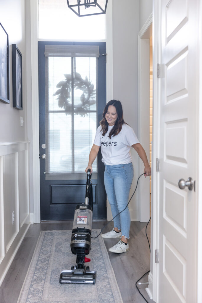 Housekeeper vacuuming a short term rental property
