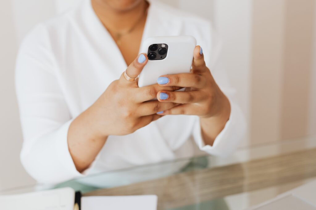 Person using their phone to automate their Airbnb business. 