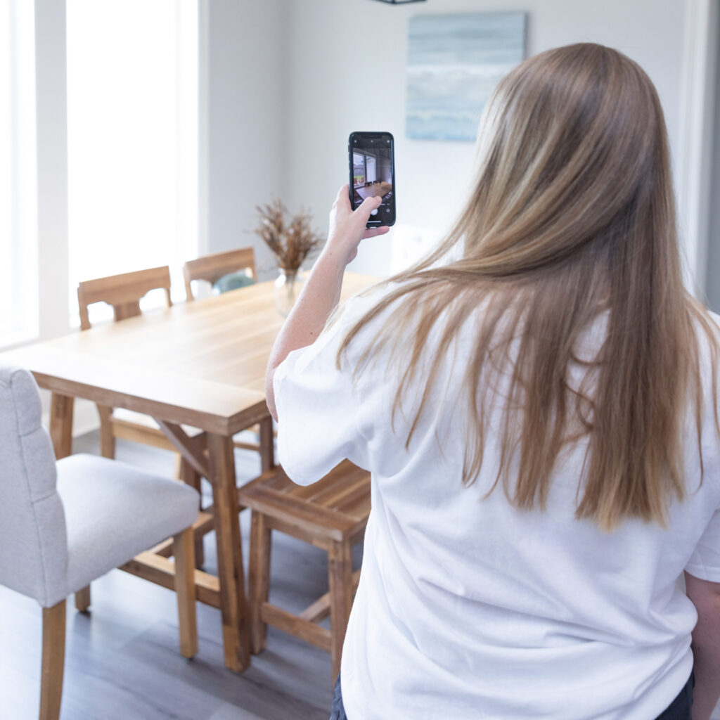housekeeper documenting clean home with a picture